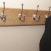 Oak coat rack pictured with hanging coat.